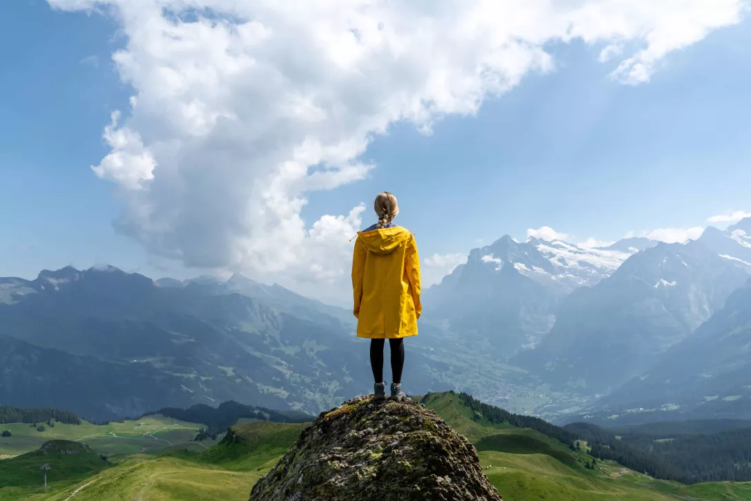 Woman standing on stone looking on mountains